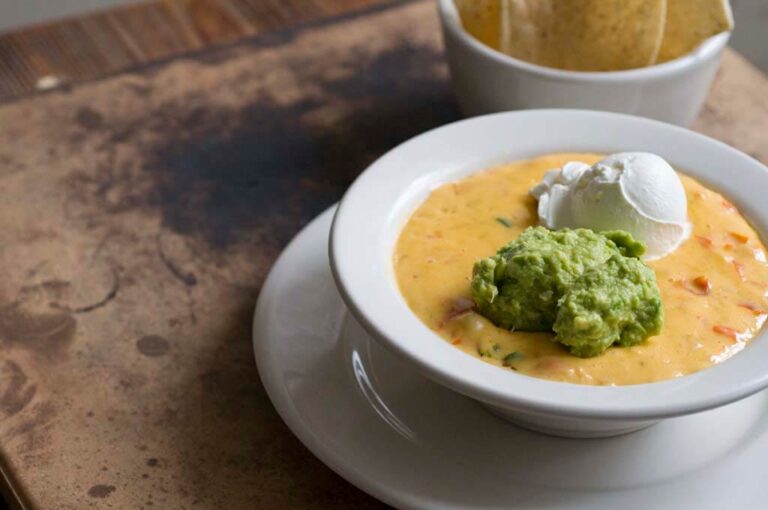 Bob Armstrong Dip: queso with taco meat, guacamole, and sour cream