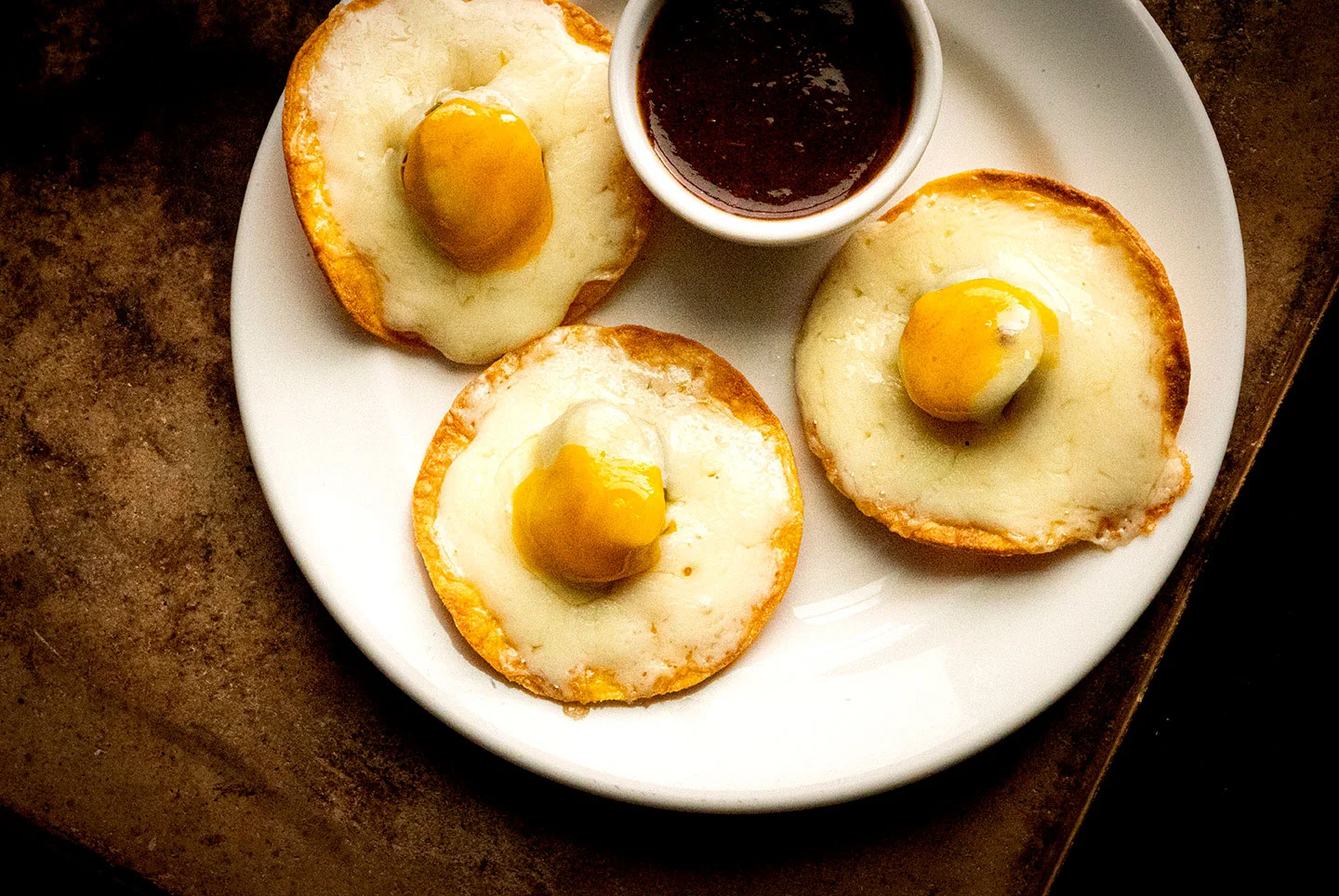 Premium Photo  Scrambled, frying eggs from one egg in a small pan on  yellow background